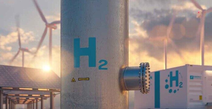Close up image of a metal pipe with the letters H and two on it in blue font